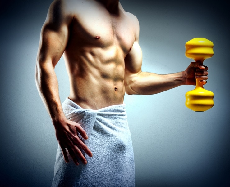 Modybuilder doing heavy weight exercise with dumbbells against d